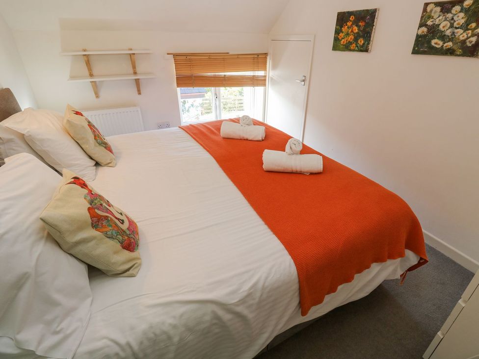 A bedroom with a bed and towels at Five Elements Barn in Truro