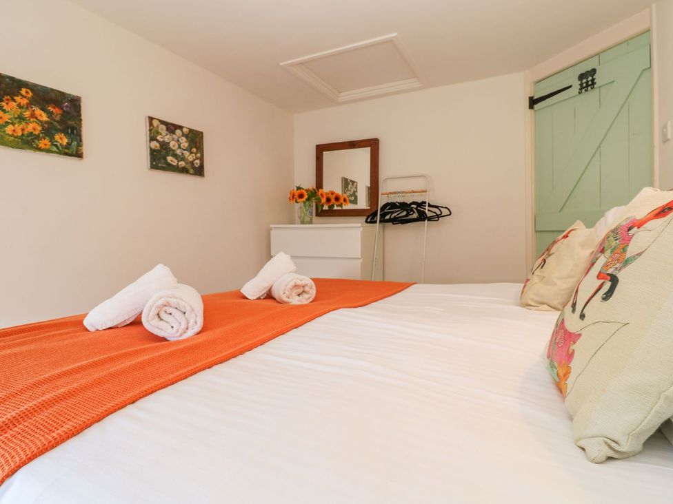 A bedroom with a bed and decorative pillows at Five Elements Barn in Truro