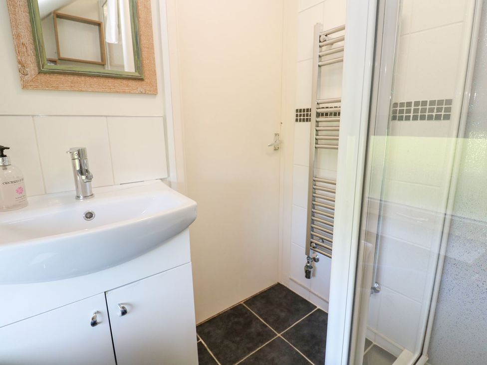 A bathroom with a sink and shower at Five Elements Barn in Truro