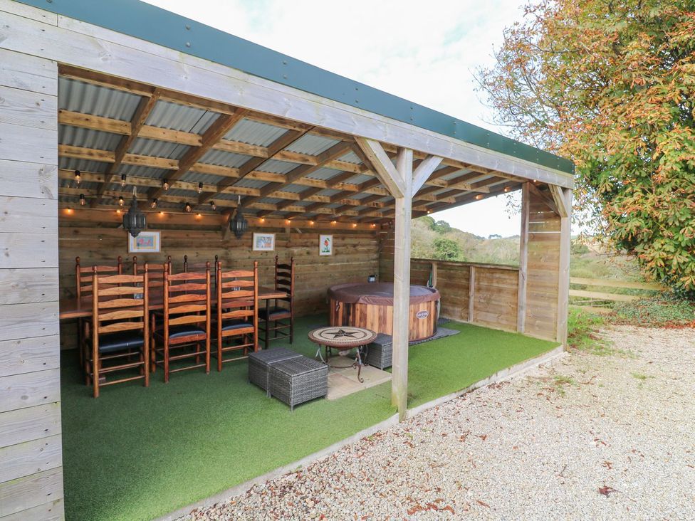 An outdoor dining area with a table and chairs at Five Elements Barn Truro