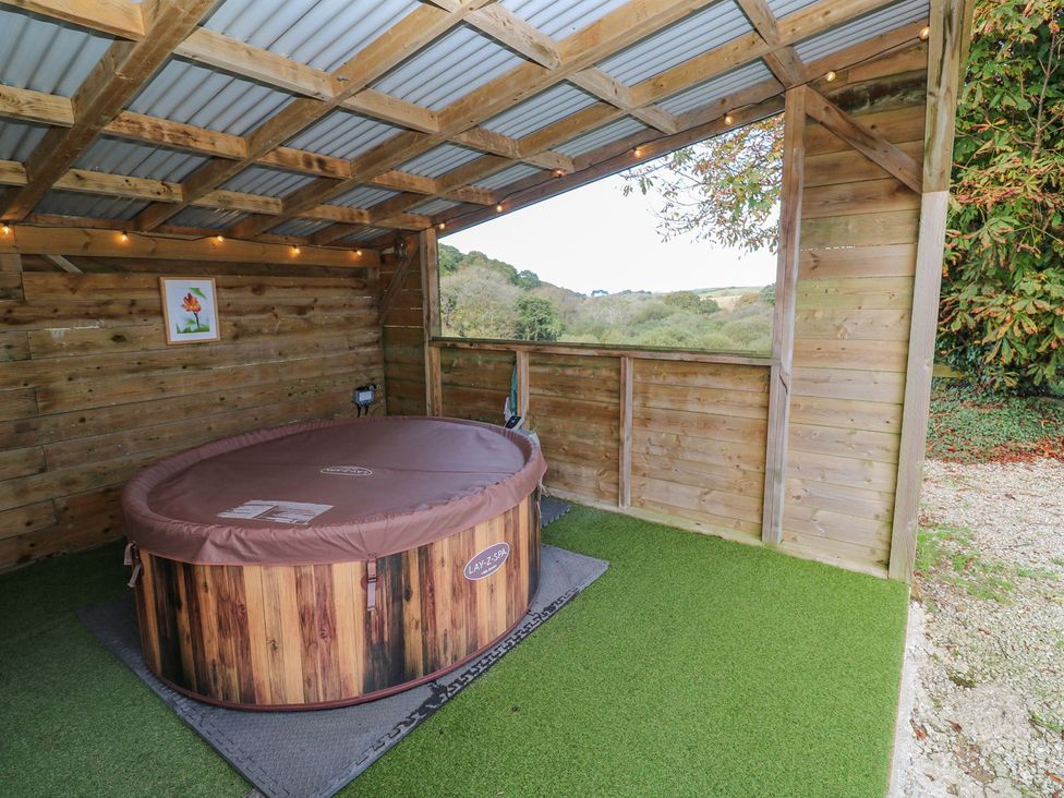 An outdoor area with a hot tub and wooden walls at Five Elements Barn in Truro