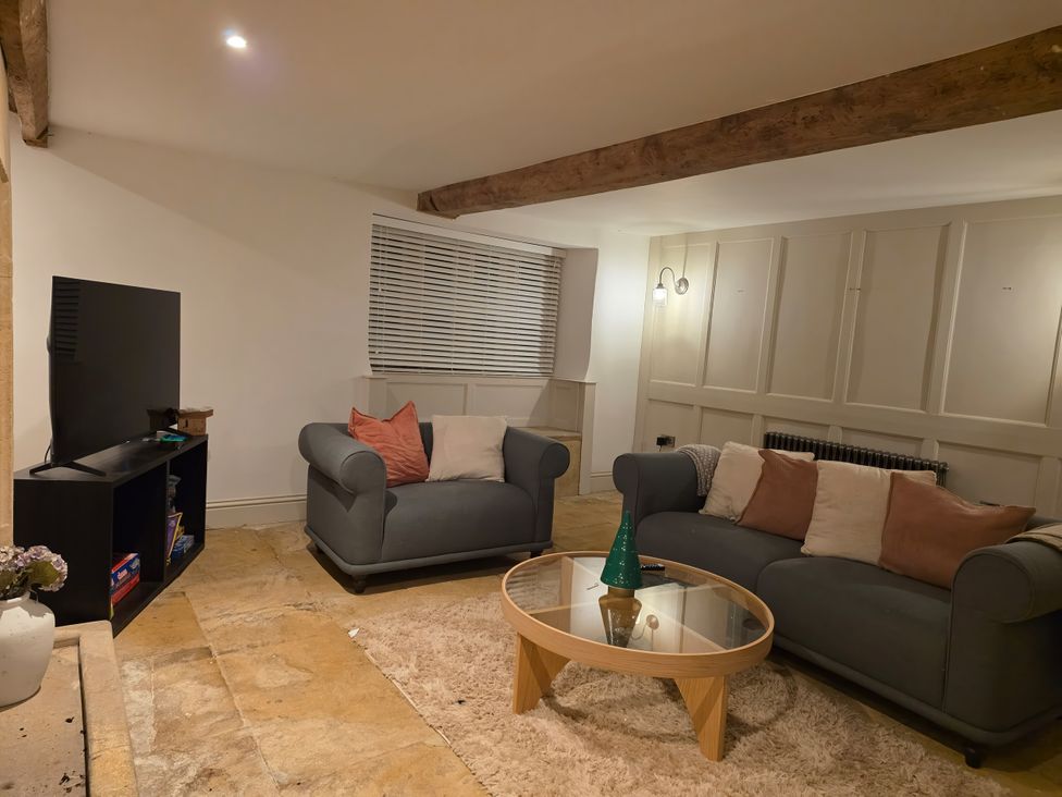 A living room with a television and two sofas at 46 North Street in Stoke-Sub-Hamdon, Somerset