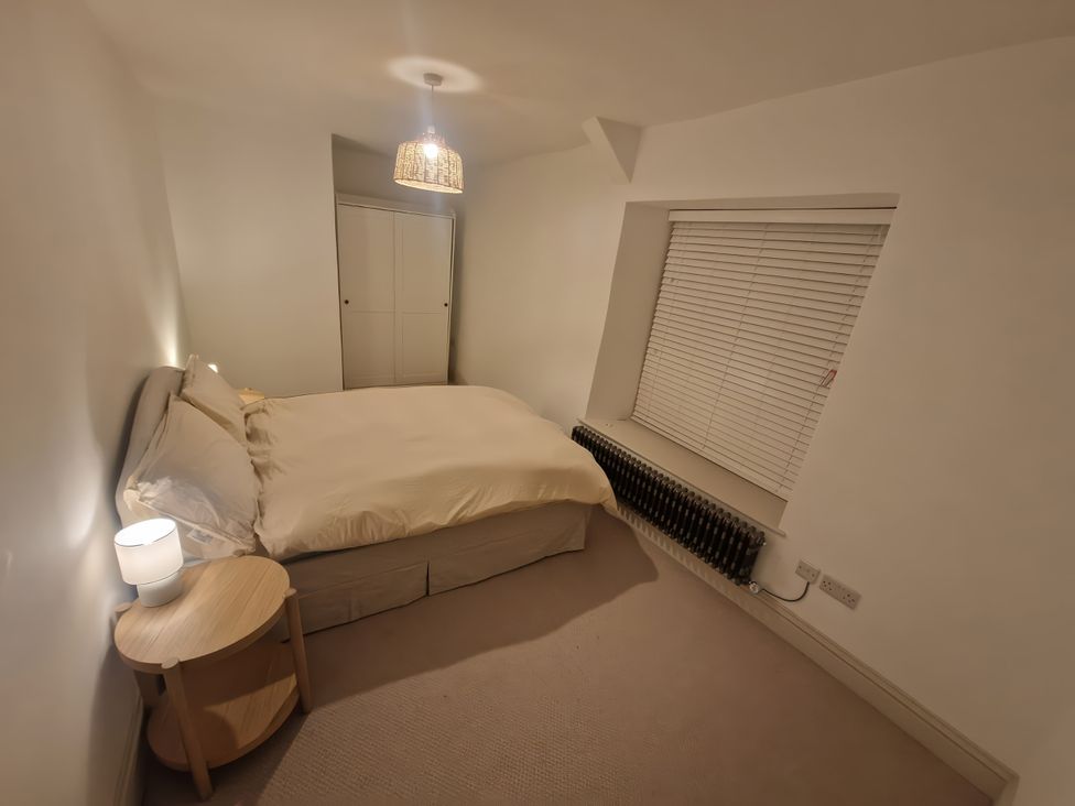 A bedroom with a bed and nightstand at 46 North Street in Stoke-Sub-Hamdon Somerset