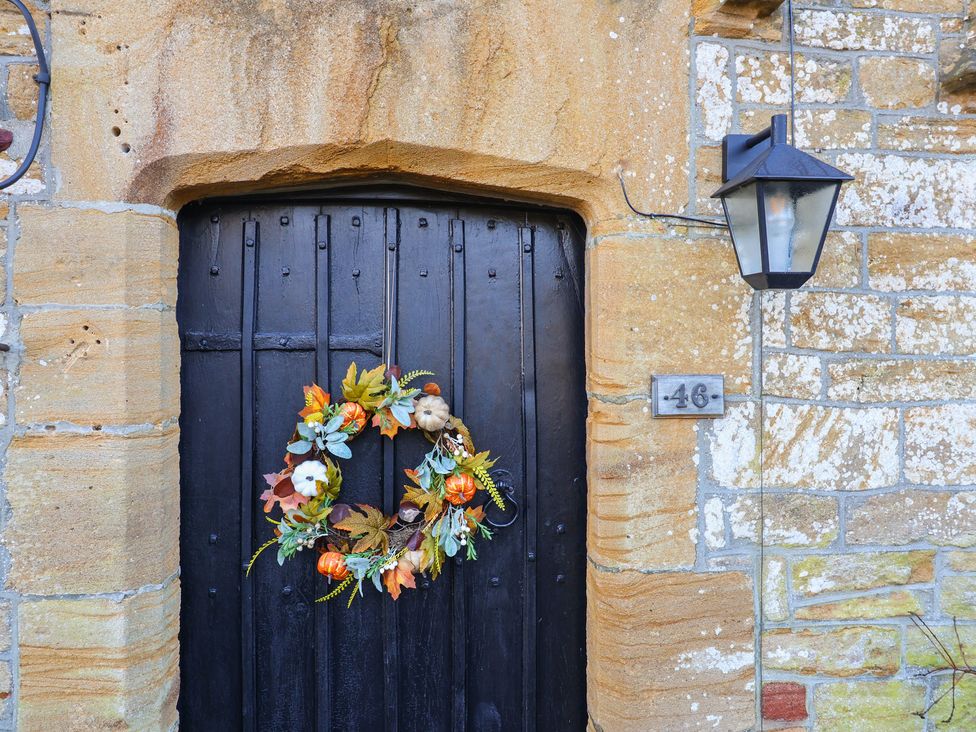 An outdoor entrance with a door and a decorative wreath at 46 North Street, Stoke-Sub-Hamdon, Somerset