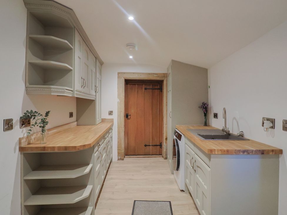 A kitchen with cabinets and a washing machine at 46 North Street Stoke-Sub-Hamdon, Somerset