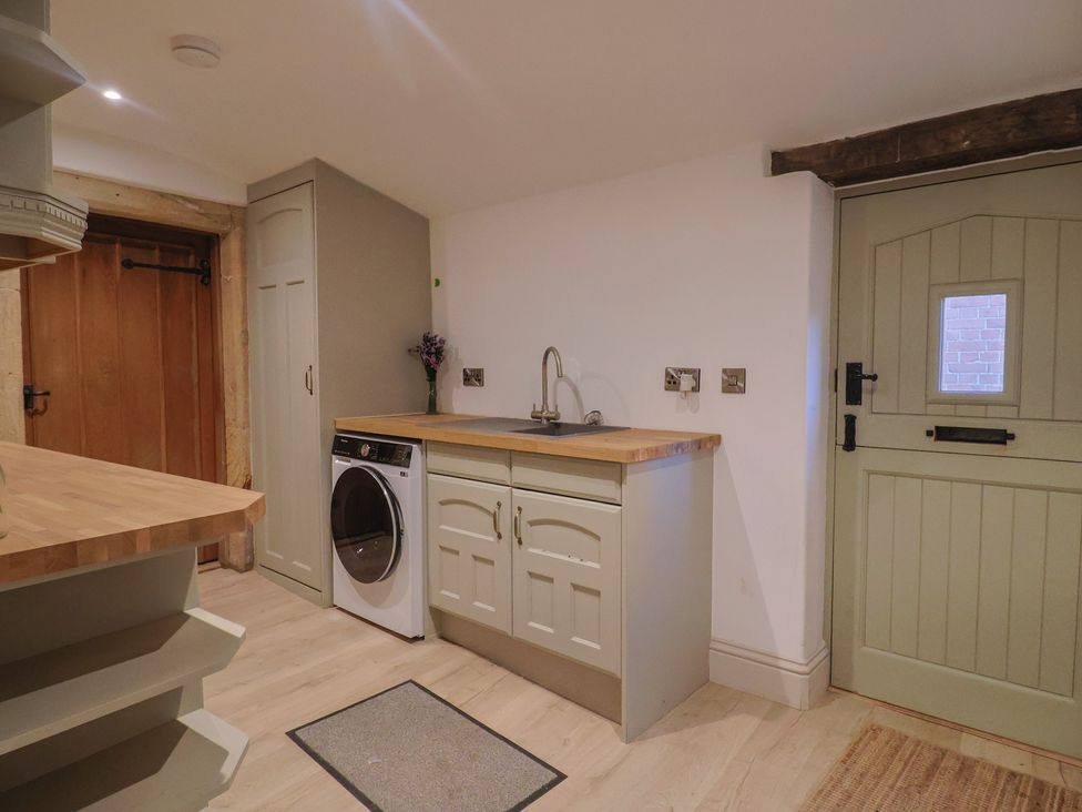 A utility room with a washing machine and sink at 46 North Street Stoke-Sub-Hamdon Somerset
