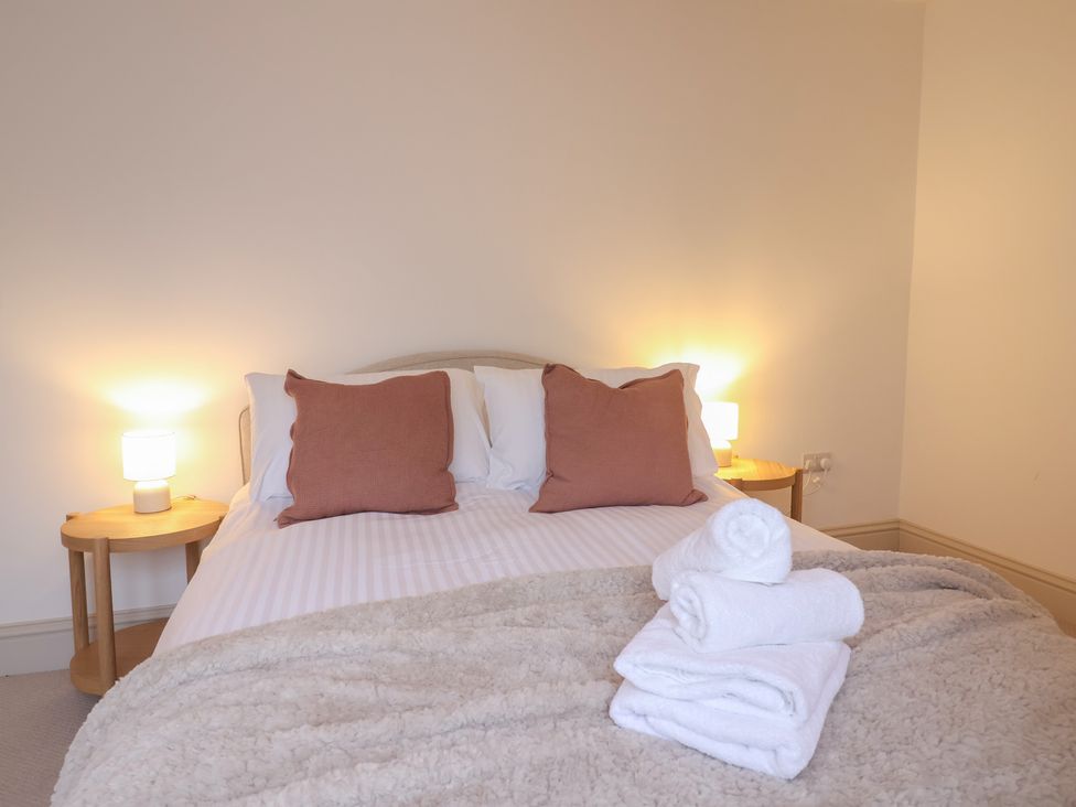 A bedroom with a bed and towels at 46 North Street, Stoke-Sub-Hamdon, Somerset