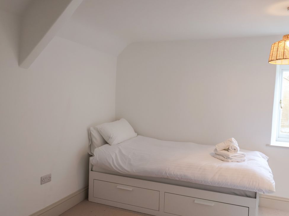 A bedroom with a bed and window at 46 North Street, Stoke-Sub-Hamdon, Somerset
