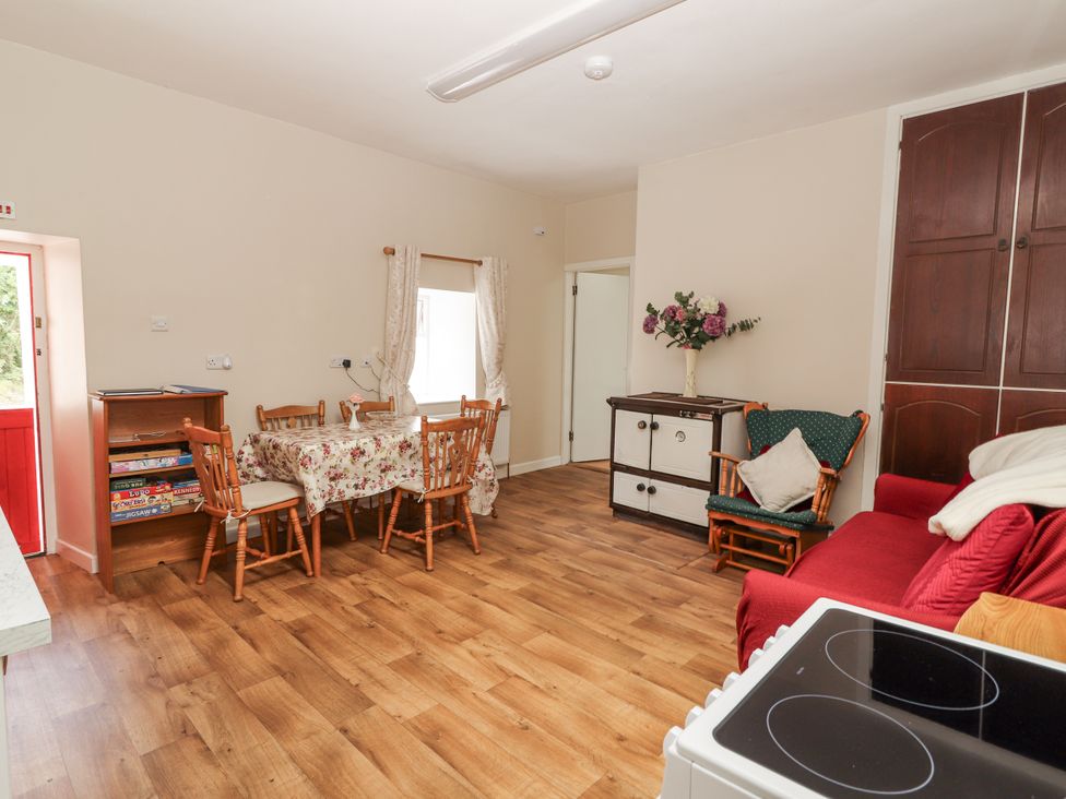 A kitchen with a dining table and chairs at Kate's Cottage