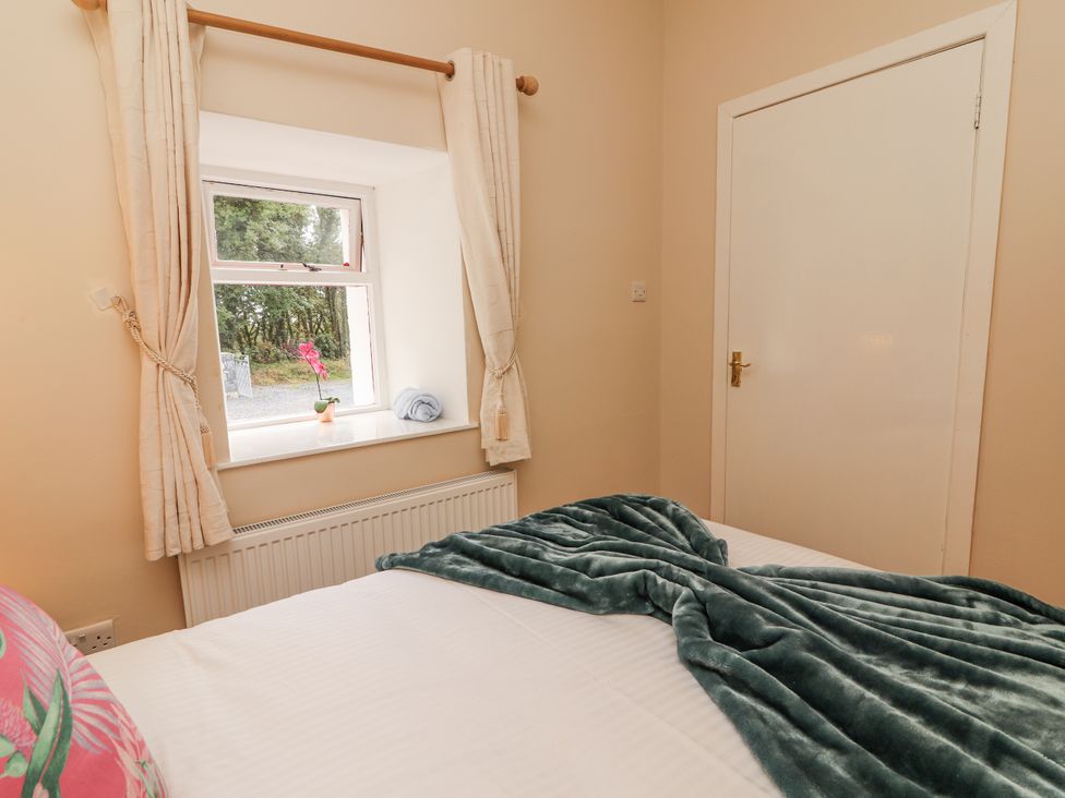 A bedroom with a window and bed at Kate's Cottage