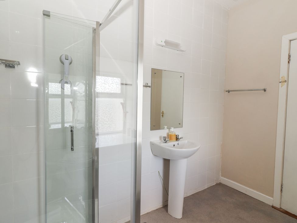 A bathroom with shower and sink at Kate's Cottage