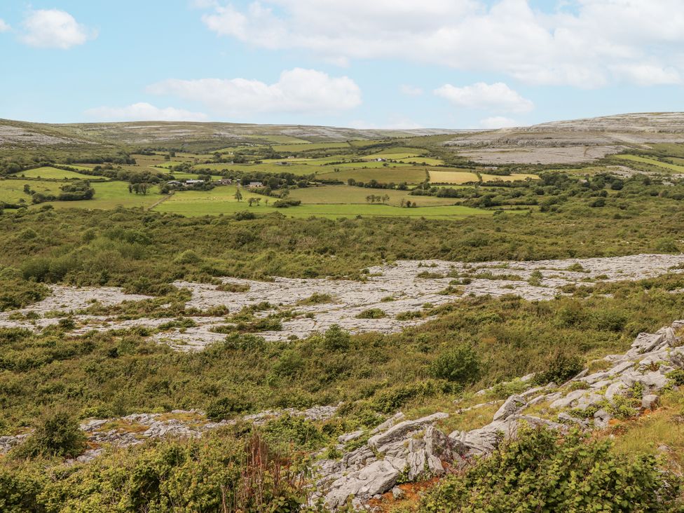A landscape featuring hills and fields with rock formations in the distance at Kate's Cottage