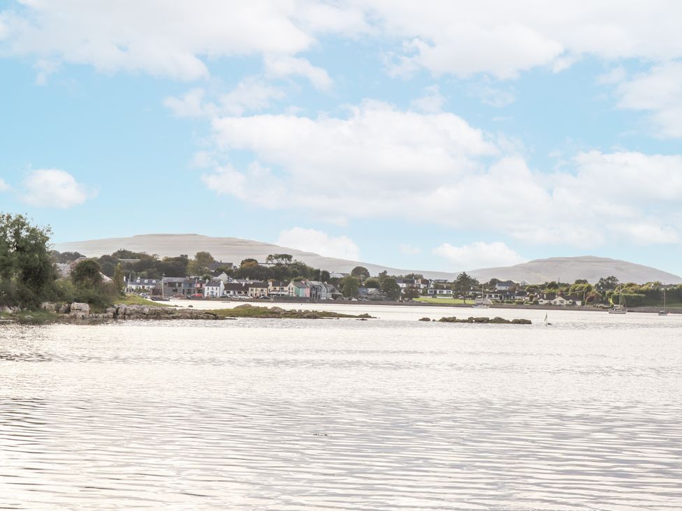 A view of houses near water with mountains in the background at Kate's Cottage