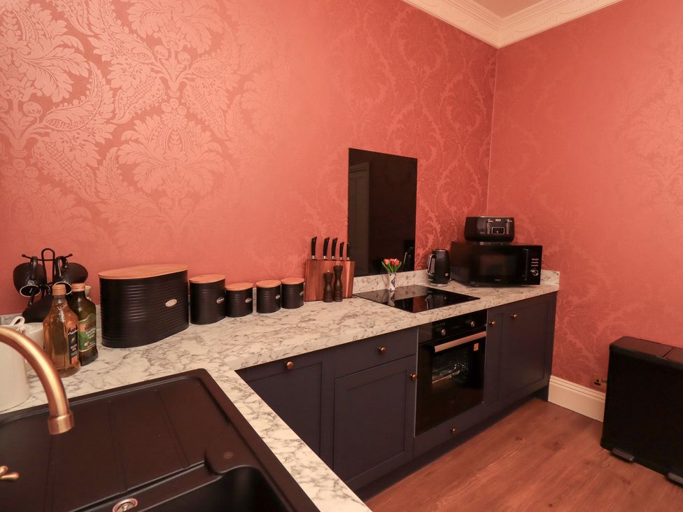 A kitchen with appliances and utensils at Summerlands Hall Apartment