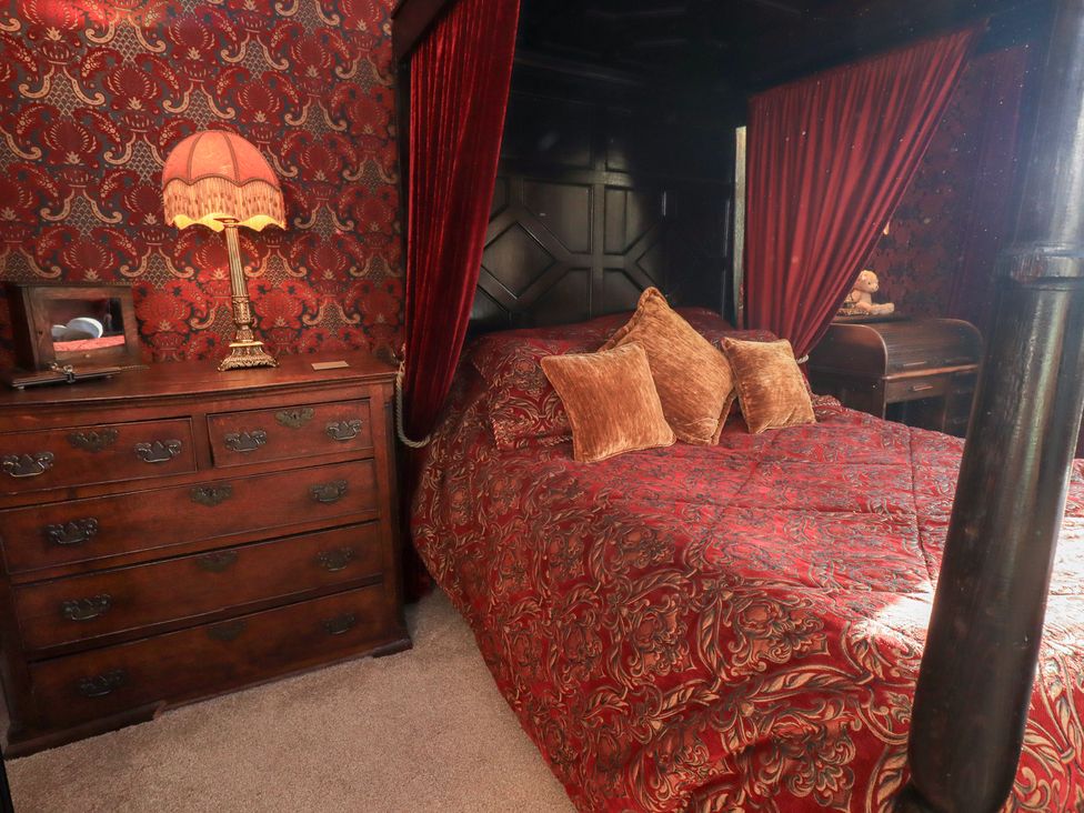 A bedroom with a bed and a dresser at Summerlands Hall Apartment