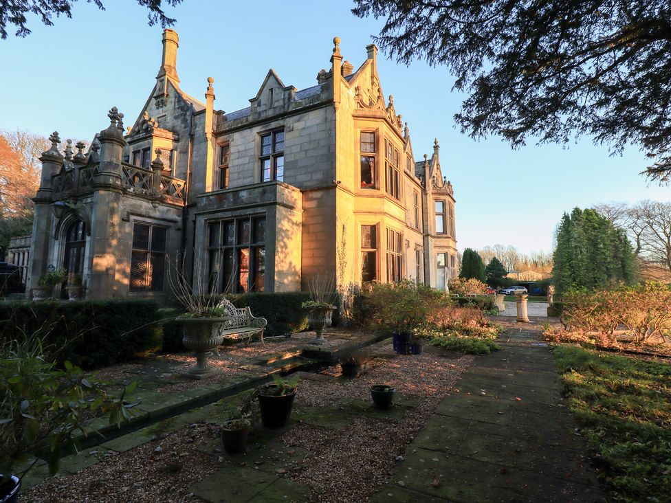 An outdoor view of a house with garden and pathway at Summerlands Hall Apartment