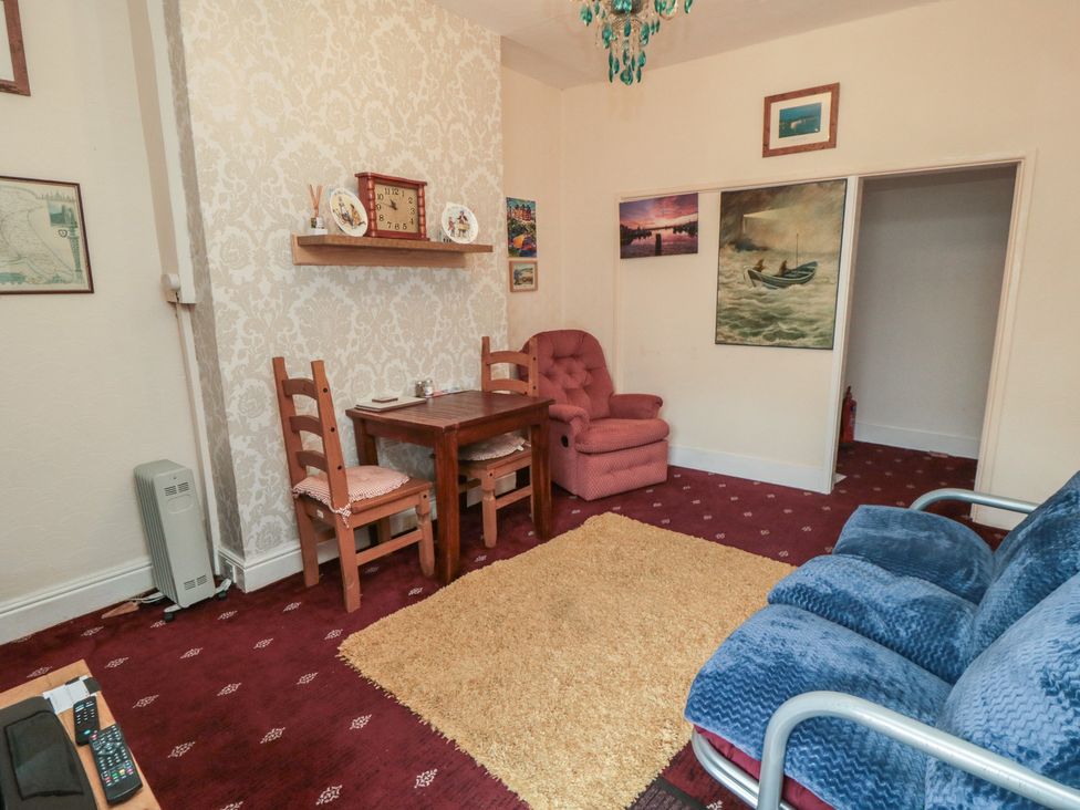 A living room with a table and chairs at 170 Victoria Road