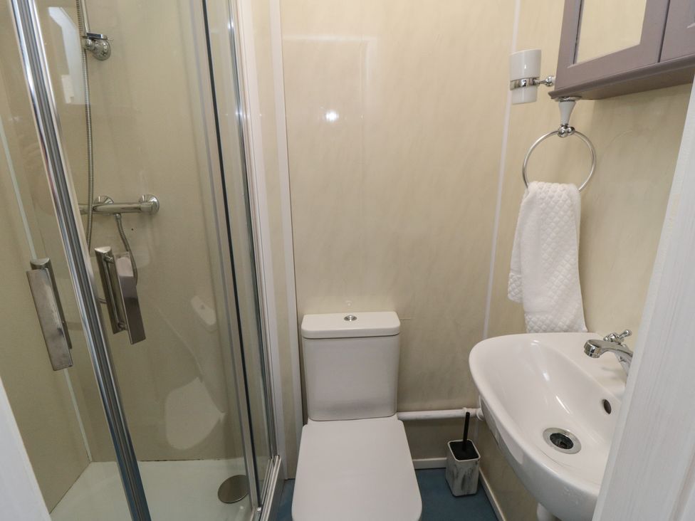 A bathroom with a shower, toilet, and sink at 170 Victoria Road 