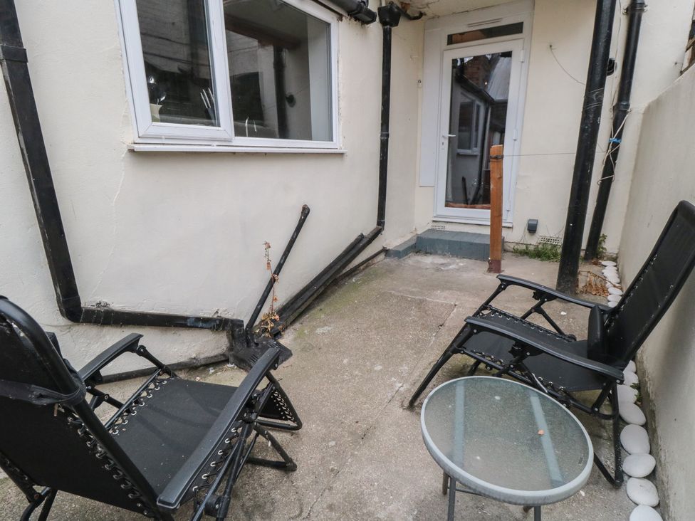 An outdoor area with chairs and a glass table at 170 Victoria Road