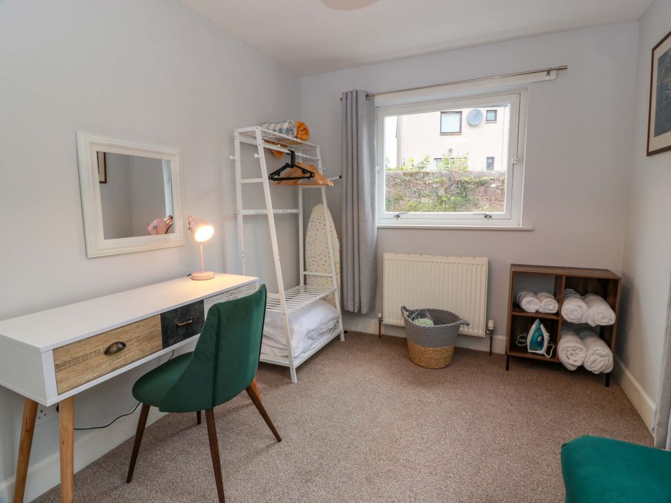A bedroom with a desk, chair, and shelf at Secret Garden @ 7