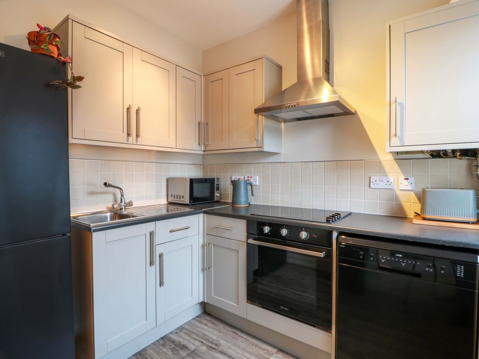 A kitchen with a refrigerator and a microwave at Secret Garden @ 7