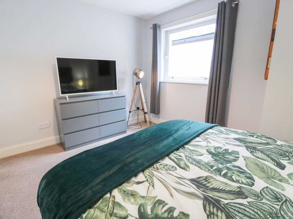 A bedroom with a bed and television at Secret Garden @ 7