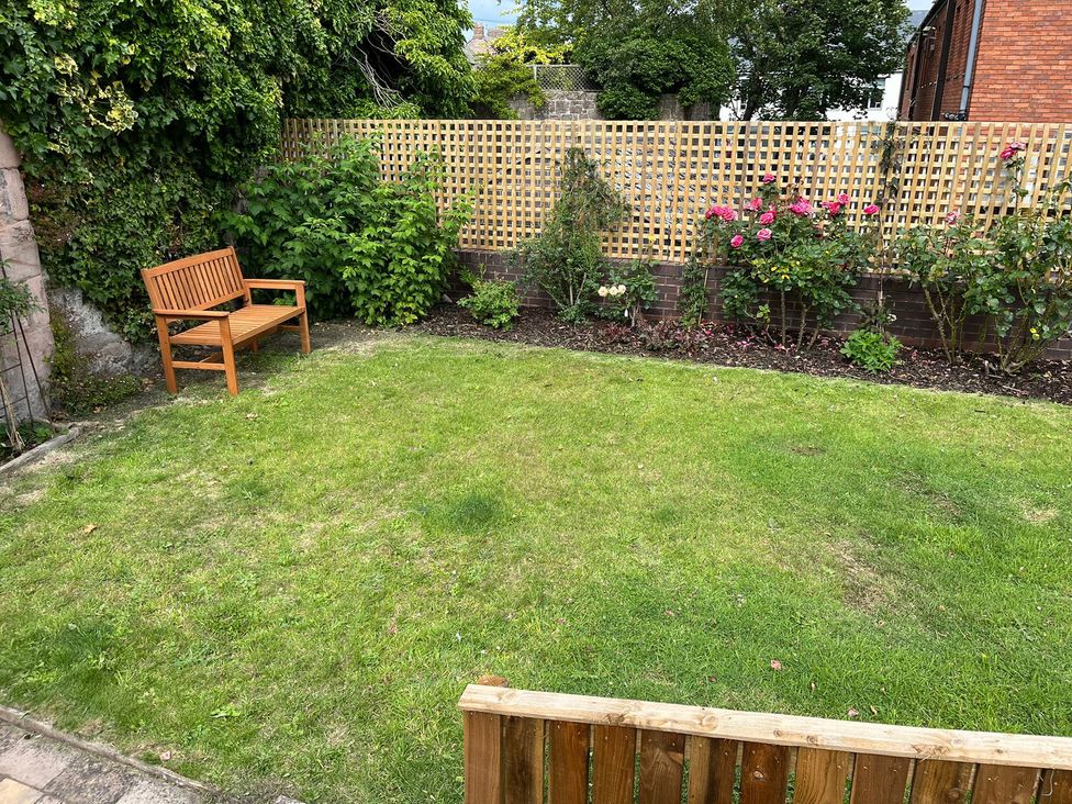 A garden with a bench and plants at Secret Garden in Berwick-Upon-Tweed