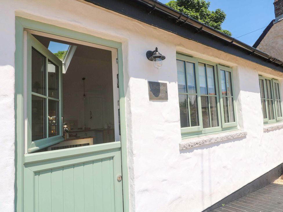 The entrance of Lavender Cottage with a green door and windows