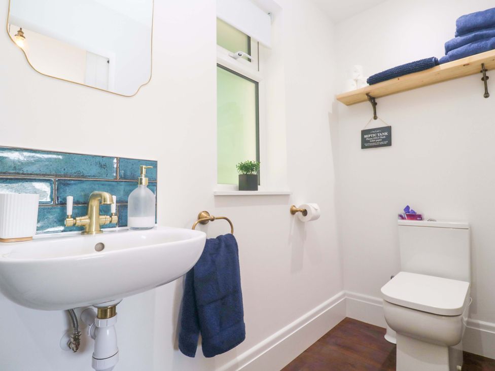 A bathroom with a sink and toilet at Lavender Cottage