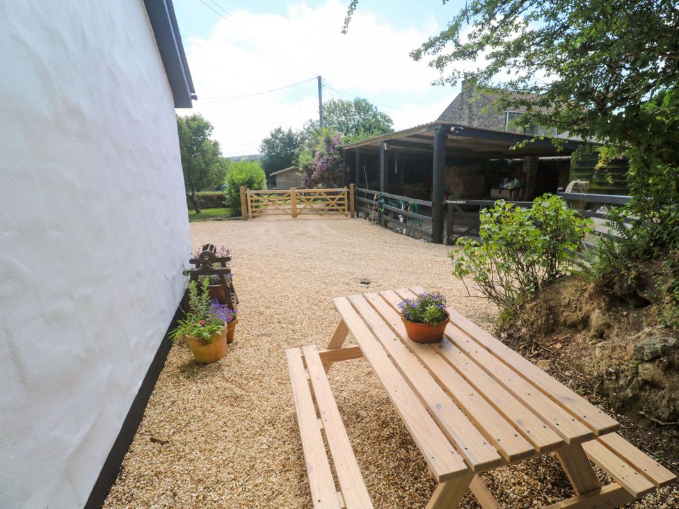 An outdoor area with a picnic table and planters at Lavender Cottage
