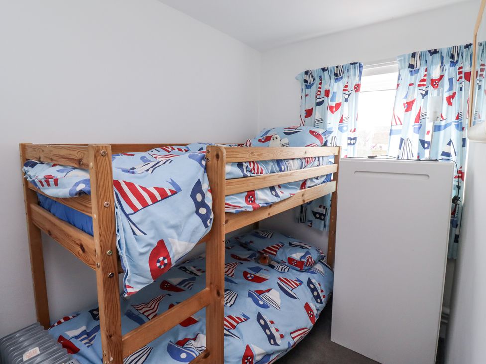 A bedroom with a bunk bed and a fridge at 51 Longstone Park