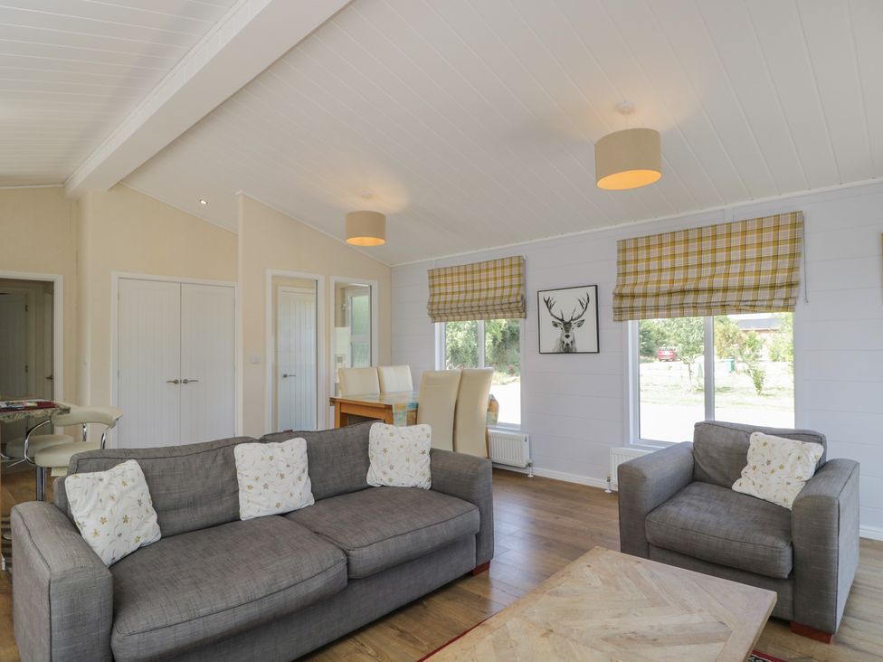 A living room with a sofa and armchairs at The Buckland in Pentridge near Sixpenny Handley