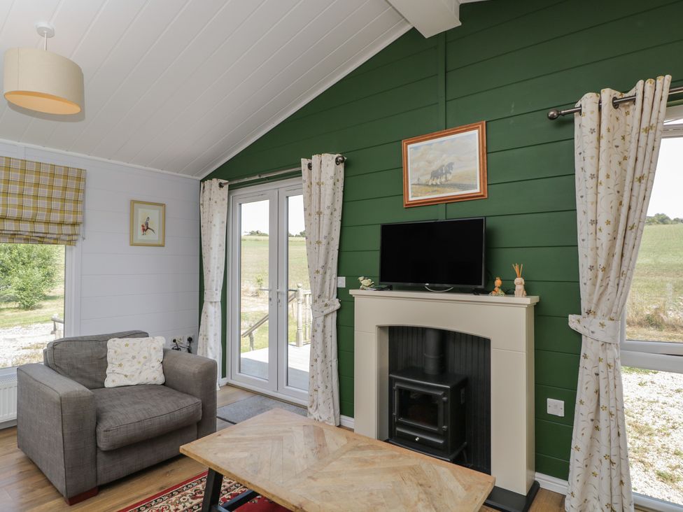 A living room with a sofa and television at The Buckland in Pentridge near Sixpenny Handley