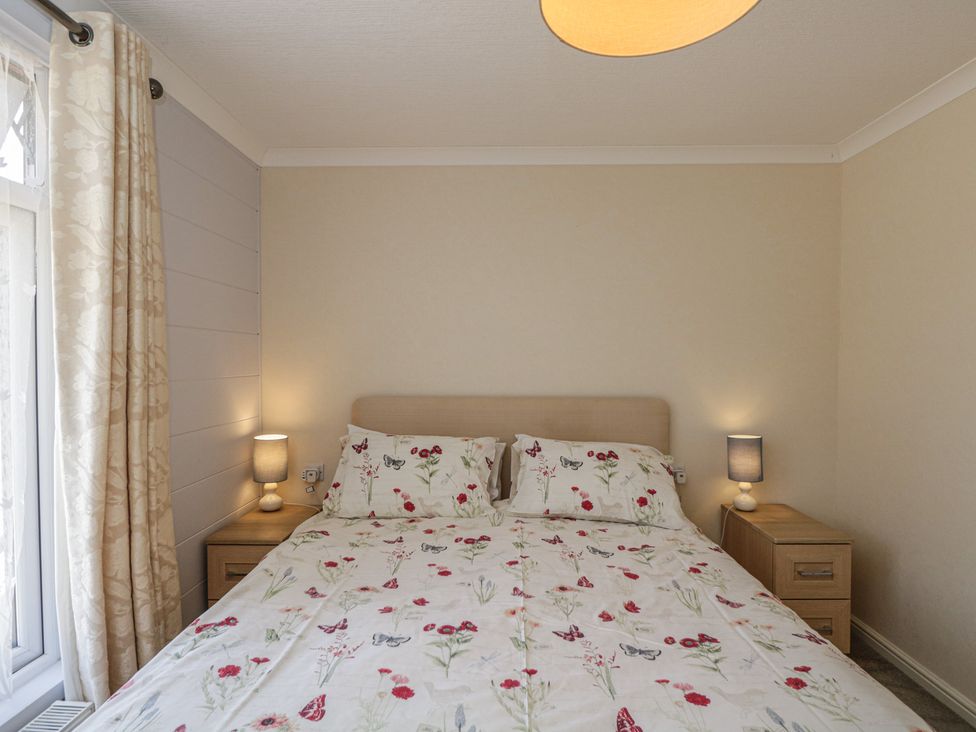 A bedroom with a bed and bedside tables at The Buckland in Pentridge near Sixpenny Handley