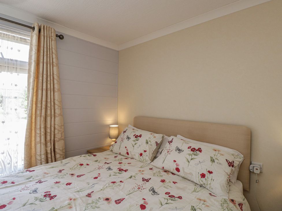 A bedroom with a bed and curtains at The Buckland Pentridge near Sixpenny Handley