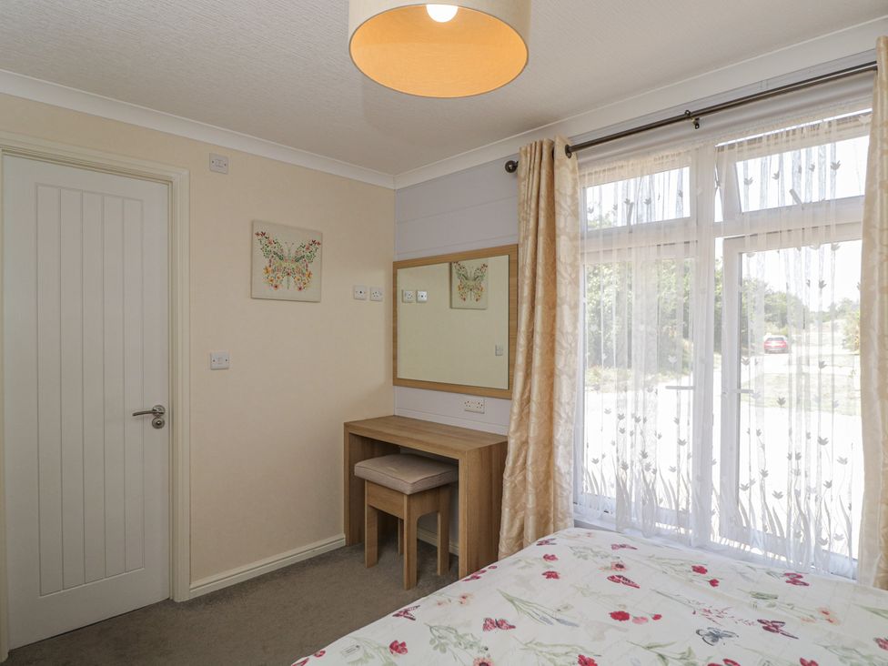 A bedroom with a bed and desk at The Buckland in Pentridge near Sixpenny Handley