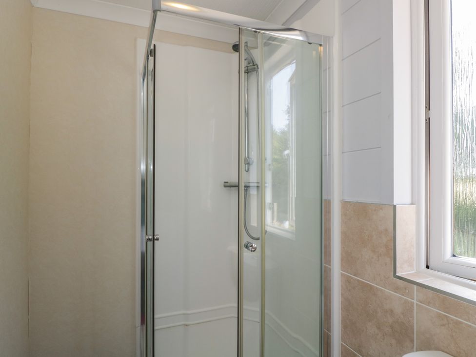 A shower enclosure with glass door at The Buckland in Pentridge near Sixpenny Handley