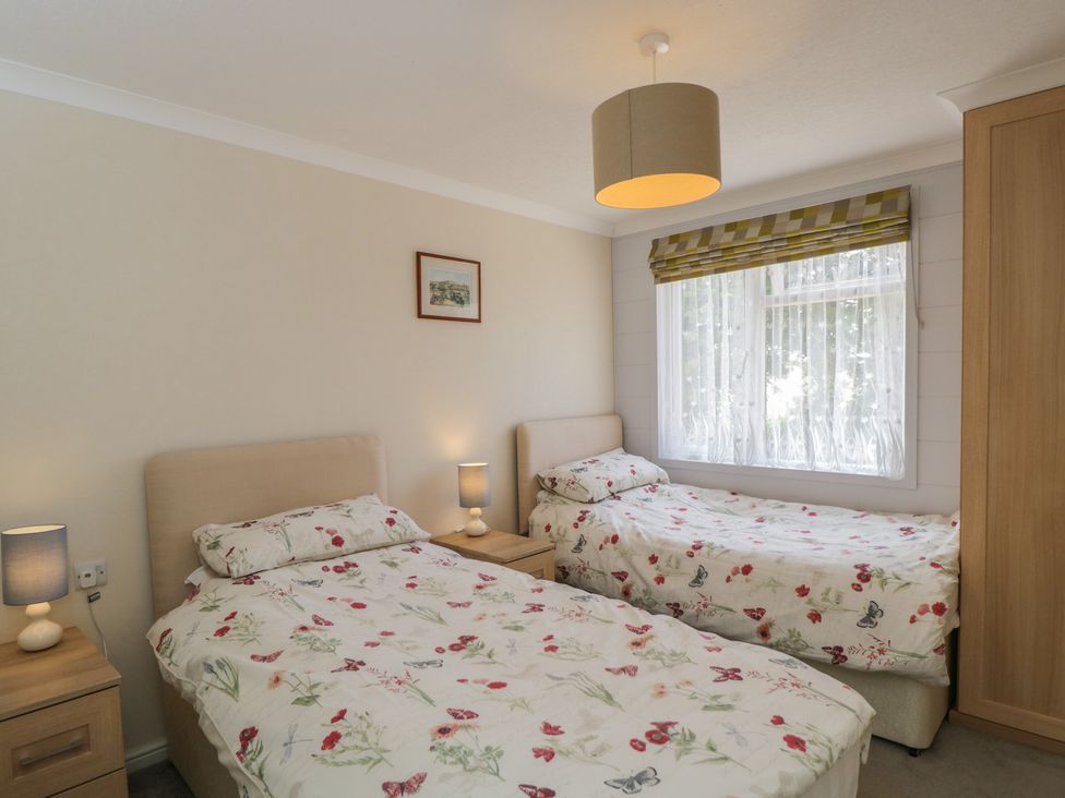 A bedroom with two beds and a window at The Buckland in Pentridge near Sixpenny Handley