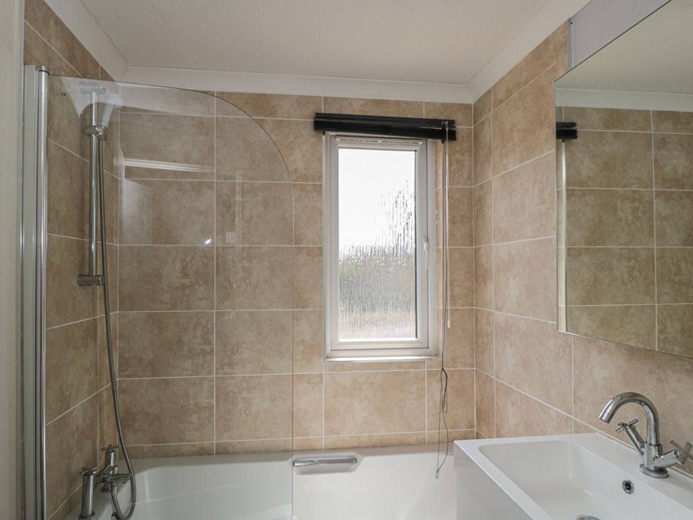 A bathroom with a shower and bathtub at The Buckland in Pentridge near Sixpenny Handley
