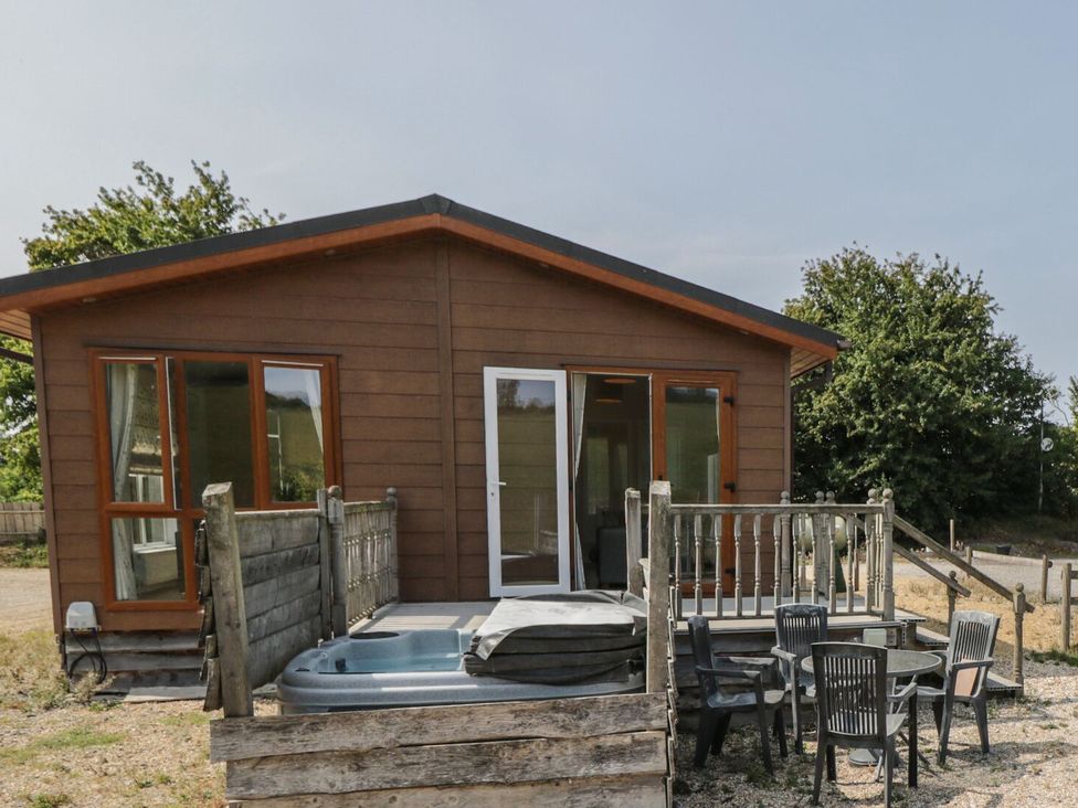 A house with a deck and hot tub at The Buckland in Pentridge near Sixpenny Handley