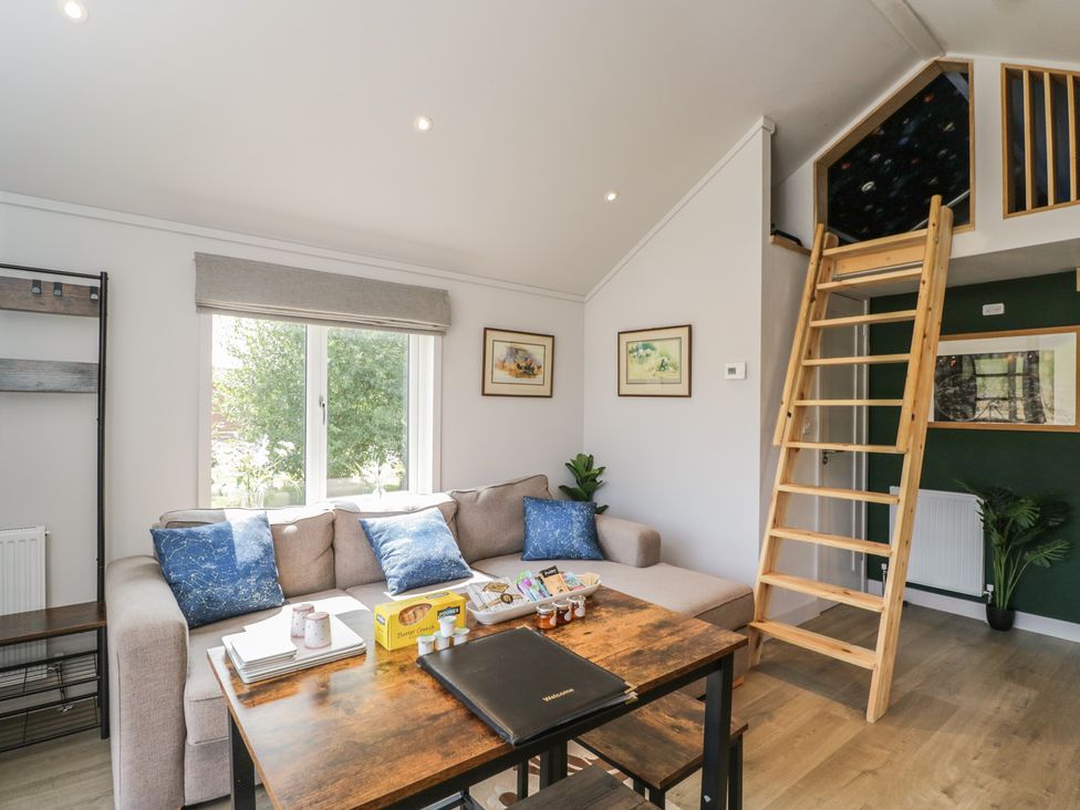A living room with a sofa and table at Cranborne Chase Stargazer in Pentridge near Sixpenny Handley