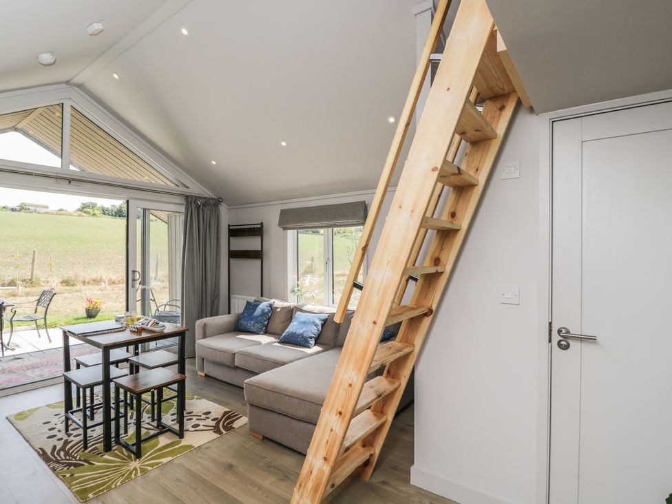A living room with a sofa and table at Cranborne Chase Stargazer Pentridge near Sixpenny Handley