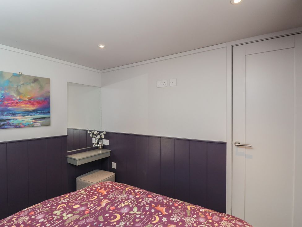 A bedroom with a mirror and table at Cranborne Chase Stargazer in Pentridge near Sixpenny Handley