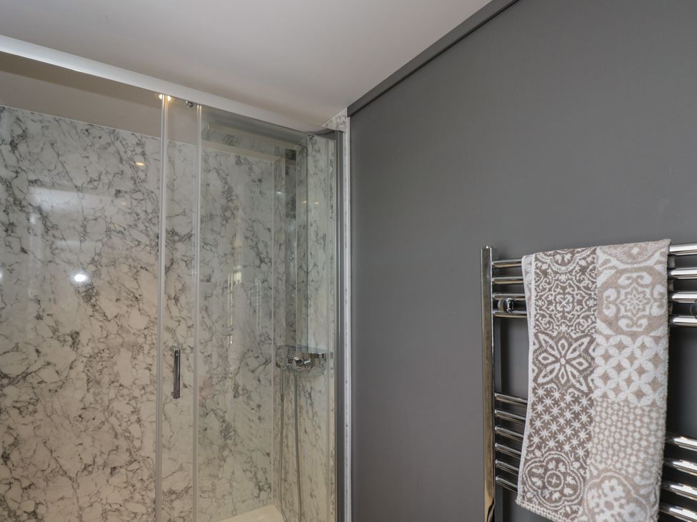 A bathroom with a shower and towel rack at Cranborne Chase Stargazer in Pentridge near Sixpenny Handley