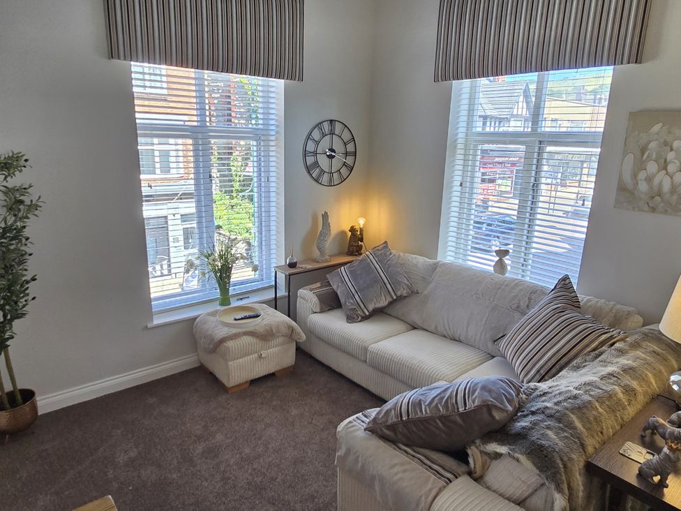A living room with a sofa and a coffee table at 2 Fern Avenue Prestatyn