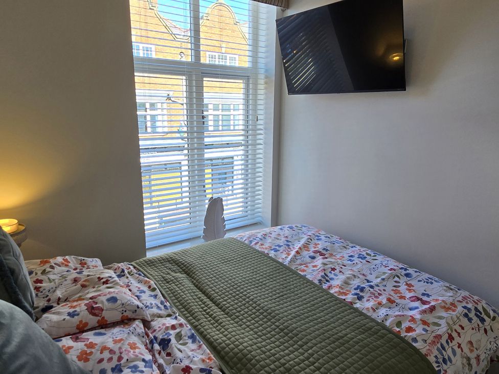 A bedroom with a bed and television at 2 Fern Avenue Prestatyn