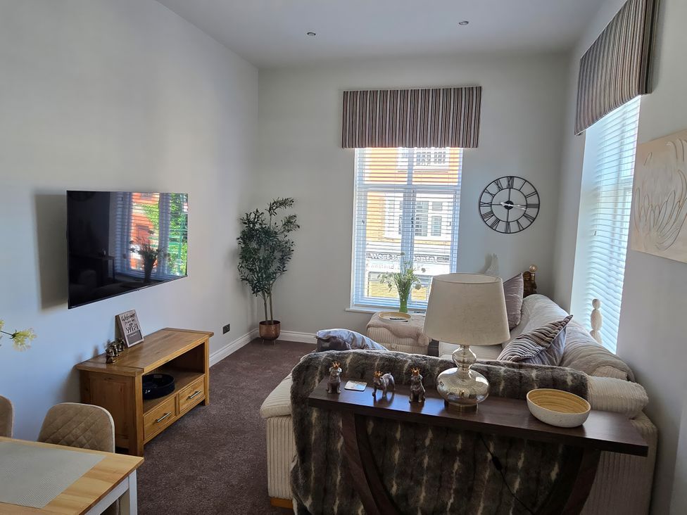 A living room with a television and sofa at 2 Fern Avenue Prestatyn