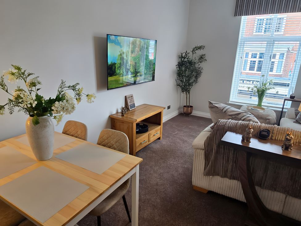 A living room with a table and chairs at 2 Fern Avenue Prestatyn