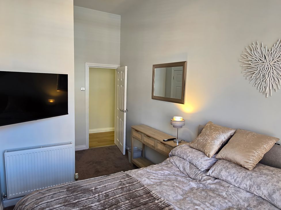 A bedroom with a bed and television at 2 Fern Avenue in Prestatyn