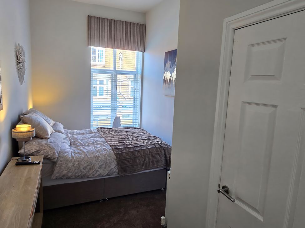 A bedroom with a bed and a window at 2 Fern Avenue in Prestatyn